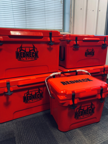 stack of red coolers with black redneck logo on them